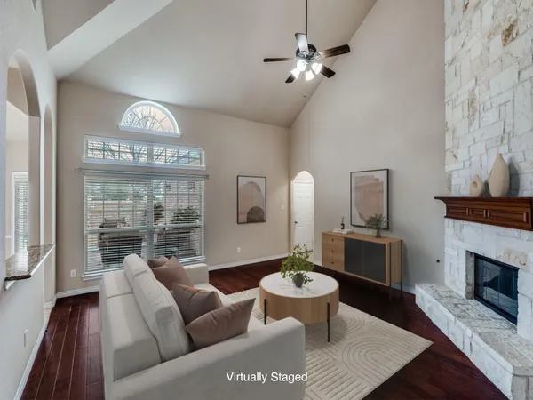 a living room with furniture a fireplace and walls