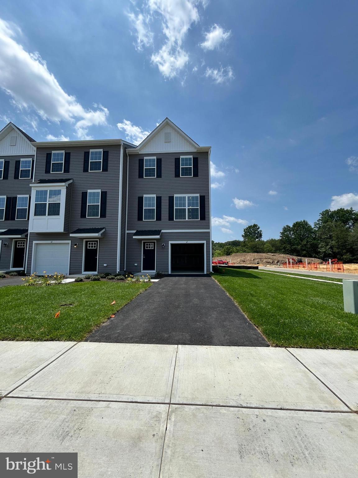 63 Barnes Way Sicklerville, NJ 08081 - Photo 3 of 49 a front view of a house with a yard and garage