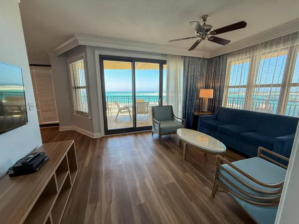 a living room with furniture and a floor to ceiling window