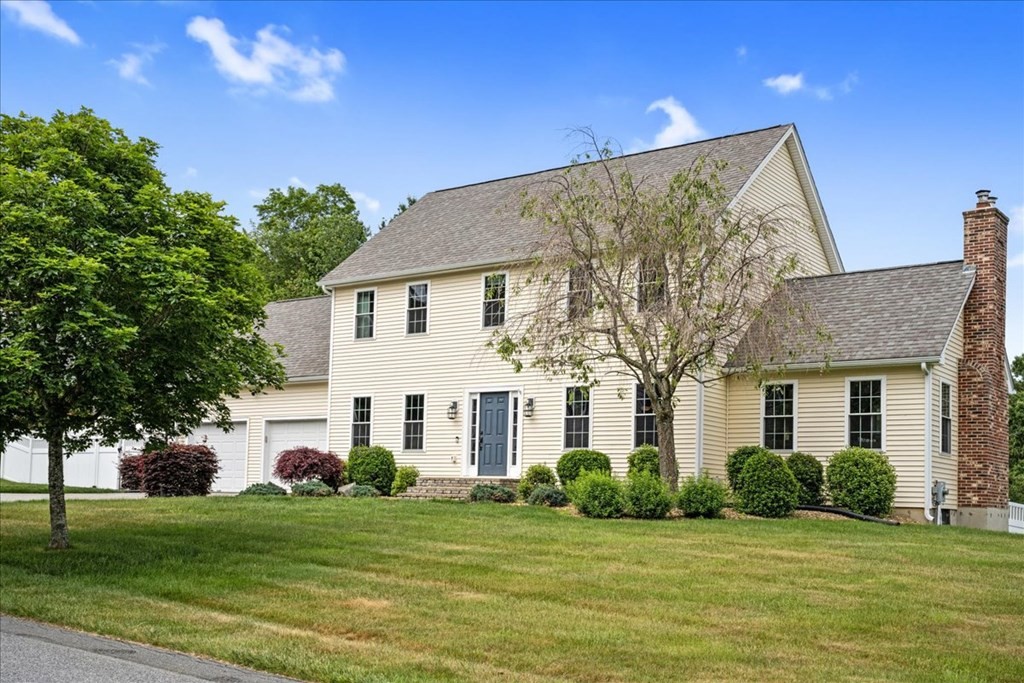 2 Harding Lane Sturbridge, MA 01518 - Photo 1 of 42 a view of a white house in front of a big yard with plants and large trees