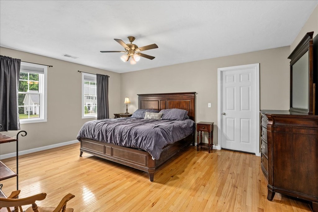 2 Harding Lane Sturbridge, MA 01518 - Photo 18 of 42 a spacious bedroom with a bed and wooden floor