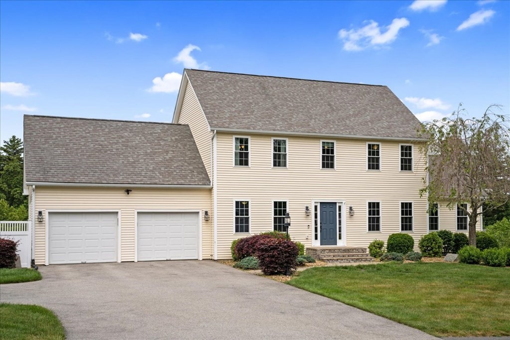 2 Harding Lane Sturbridge, MA 01518 - Photo 2 of 42 a front view of a house with a yard and garage