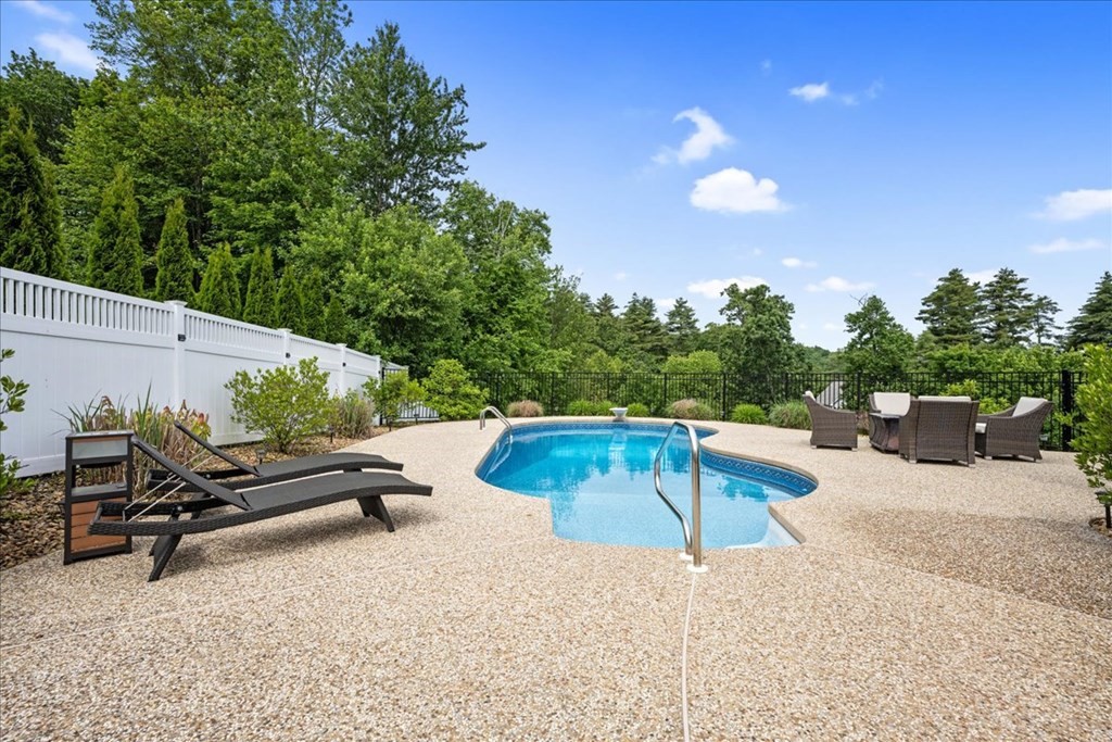 2 Harding Lane Sturbridge, MA 01518 - Photo 34 of 42 a view of a swimming pool with a lounge chair and floor to ceiling window