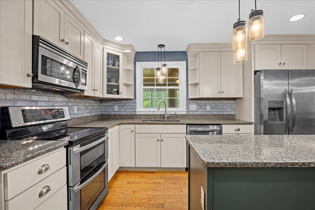 2 Harding Lane Sturbridge, MA 01518 - Photo 4 of 42 a kitchen with stainless steel appliances granite countertop a sink stove and microwave