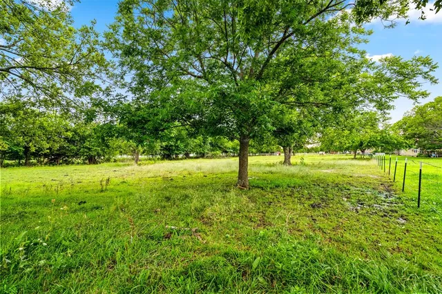 a view of a water pond with green field