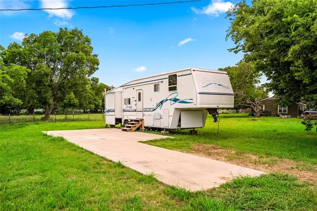 an aerial view of residential houses with outdoor space and street view