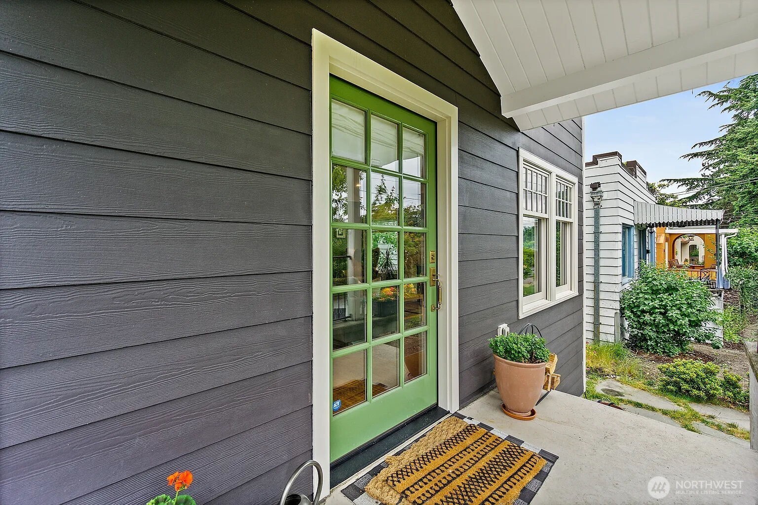 1114 North 77th Street Seattle, WA 98103 - Photo 3 of 30 a view of a house with porch and garden