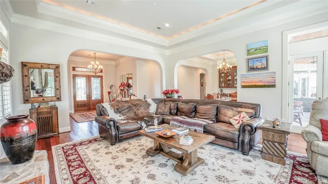 a view of a dining room with furniture wooden floor and chandelier