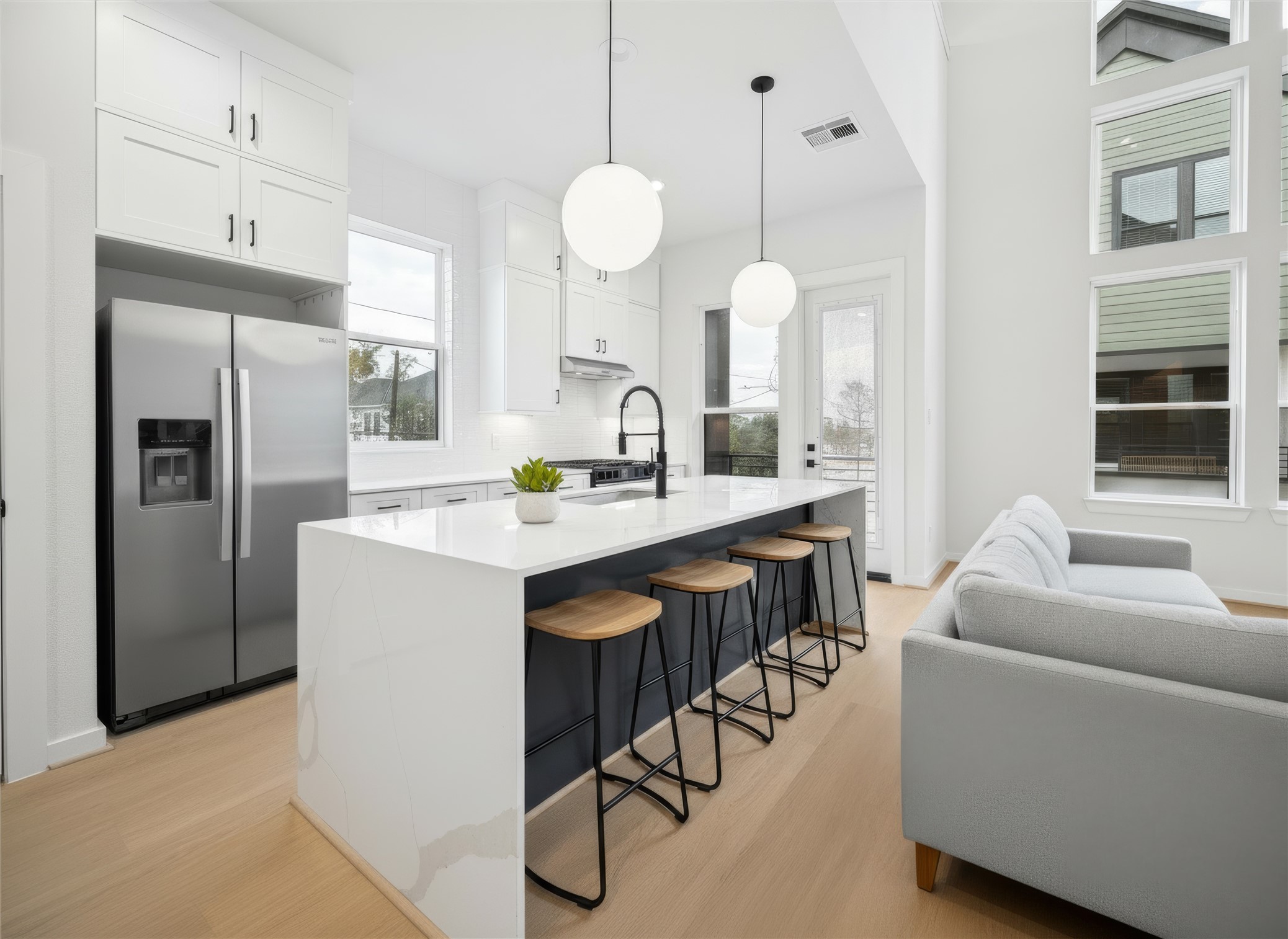 817 Thornton Road, Unit G Houston, TX 77018 - Photo 9 of 49 Chef inspired kitchen with sleek dark cabinetry, under-cabinet lighting, and a spacious island for gathering. *Virtually staged*
