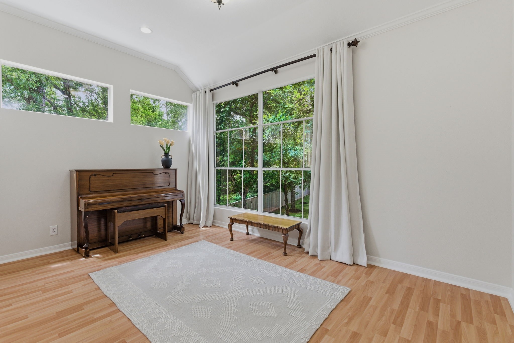 11 Dovewing Place Spring, TX 77382 - Photo 13 of 32 Bright and airy upstairs retreat with large windows overlooking greenery. Features light wood flooring, white walls, and ample natural light.