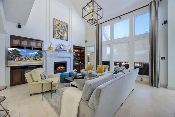 a living room with furniture a flat screen tv and a fireplace