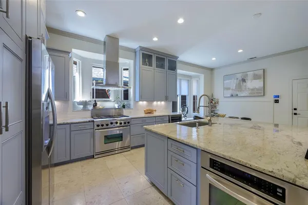 a kitchen with a sink stove and refrigerator