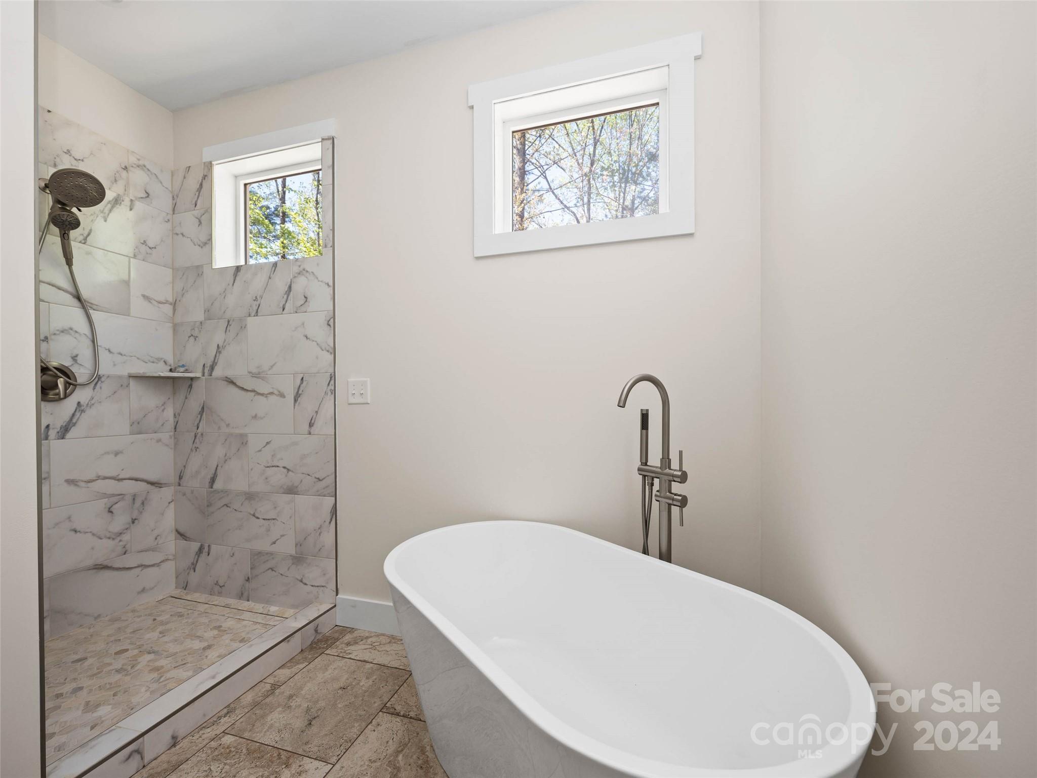 359 Tiptop Road Brevard, NC 28712 - Photo 14 of 48 a bathroom with a sink a toilet and shower