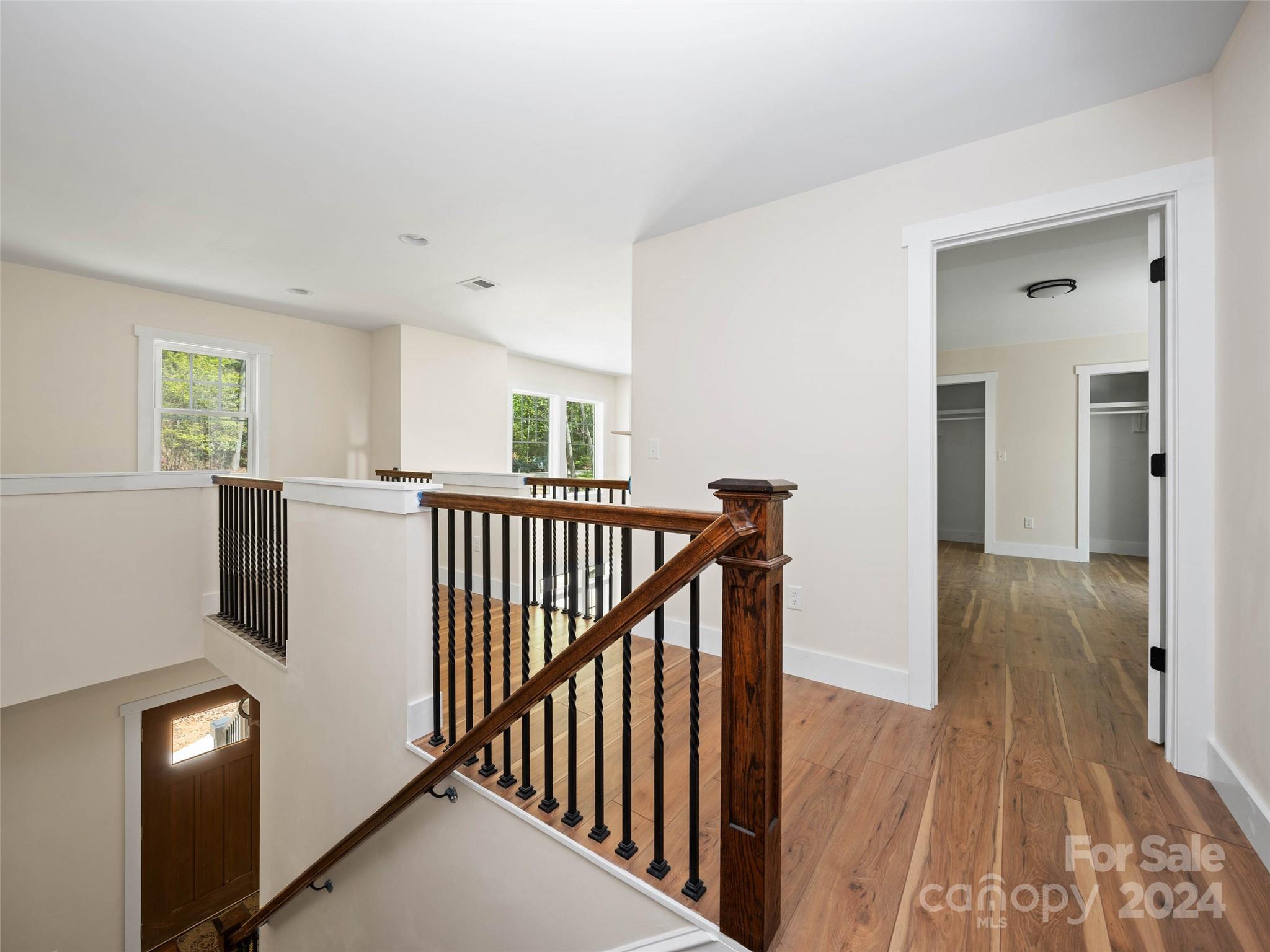 359 Tiptop Road Brevard, NC 28712 - Photo 22 of 48 a view of a hallway with wooden floor and windows