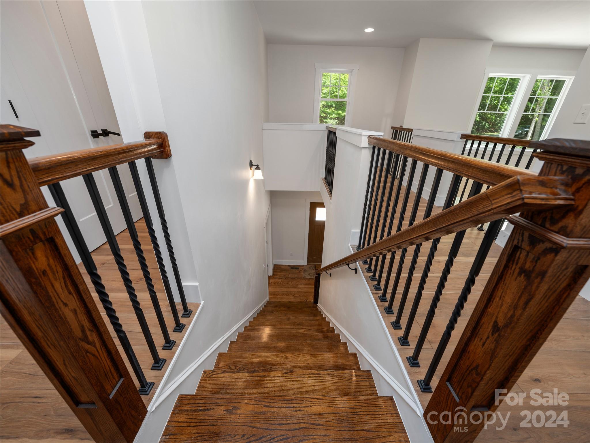 359 Tiptop Road Brevard, NC 28712 - Photo 23 of 48 a view of a hallway with wooden floor and stairs