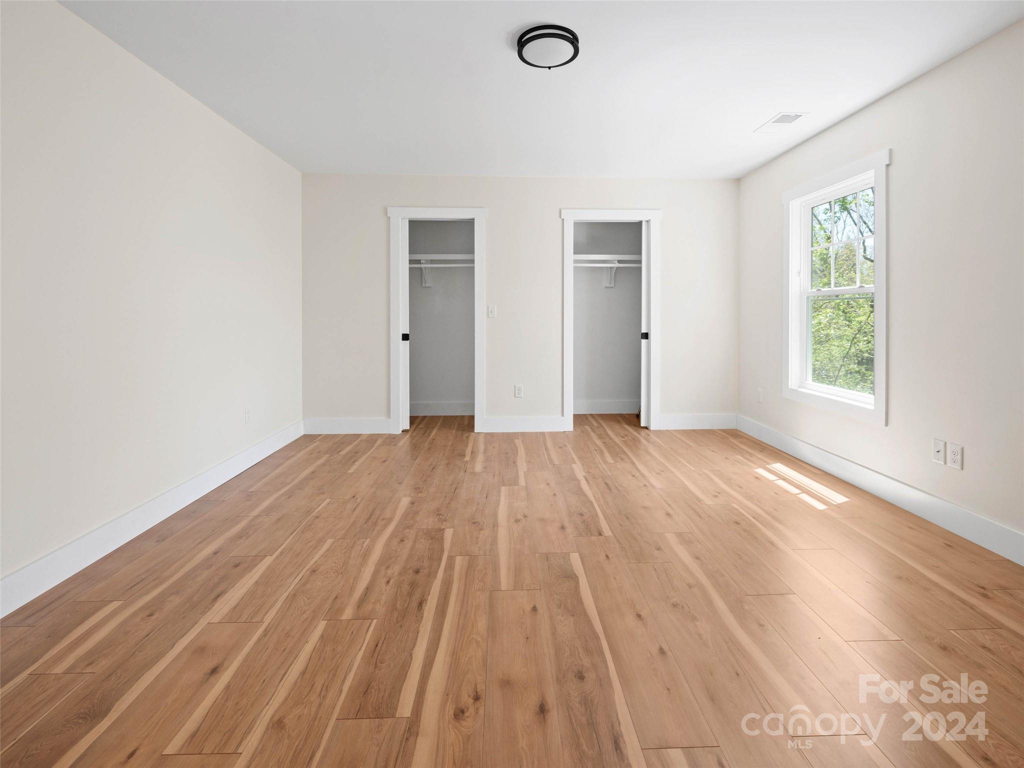 359 Tiptop Road Brevard, NC 28712 - Photo 24 of 48 an empty room with wooden floor and windows