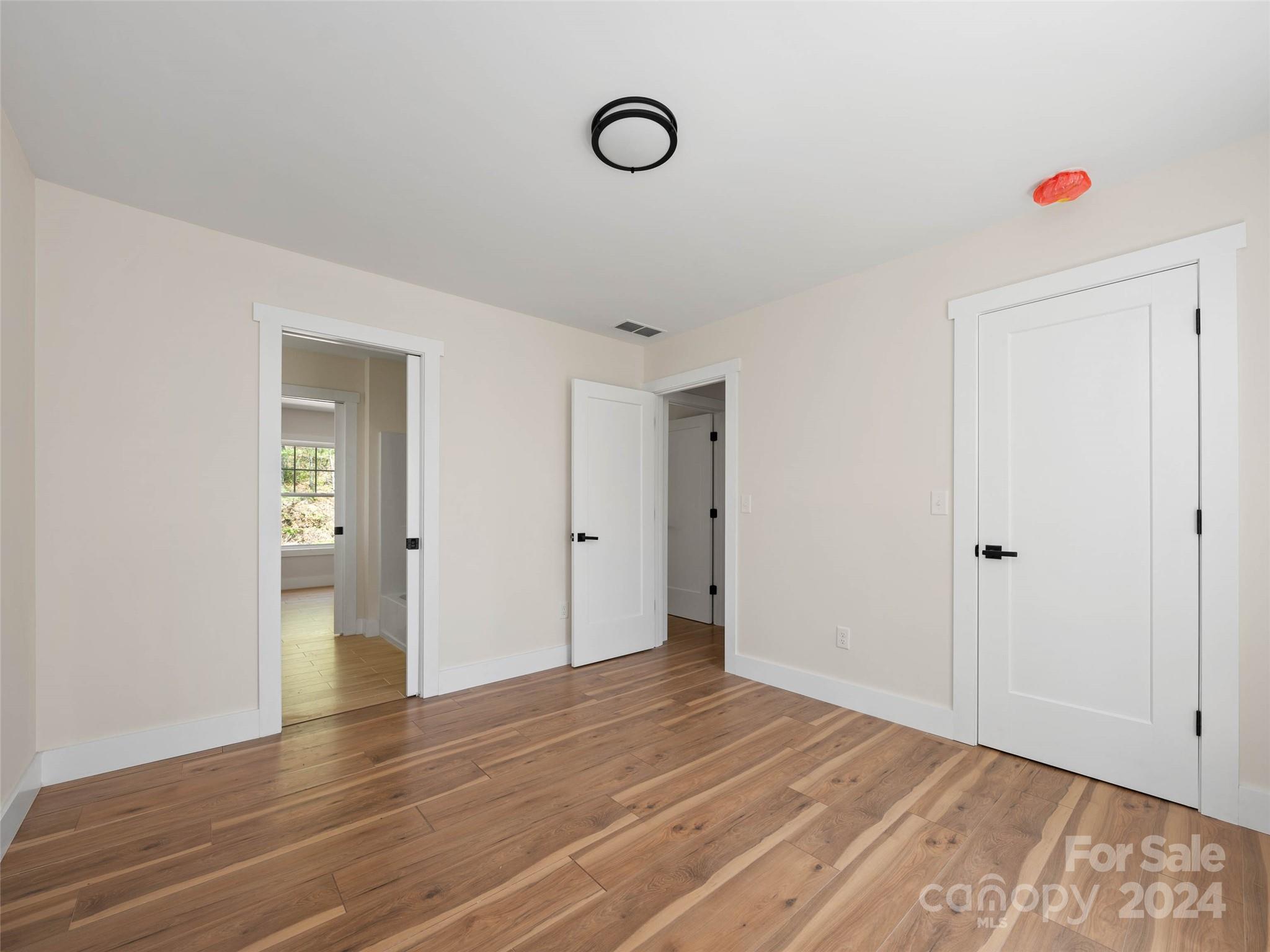 359 Tiptop Road Brevard, NC 28712 - Photo 27 of 48 a view of empty room with wooden floor and fan