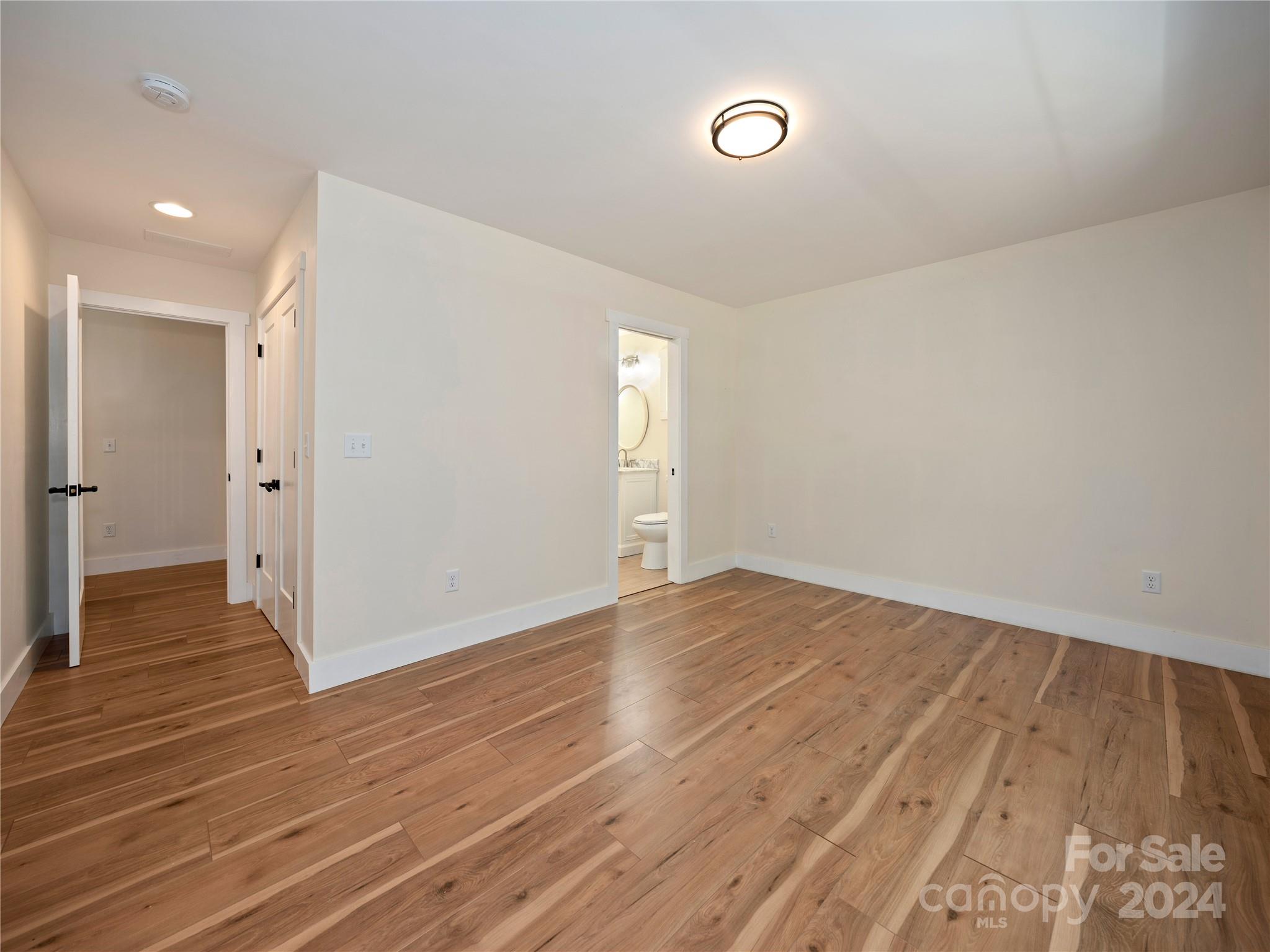 359 Tiptop Road Brevard, NC 28712 - Photo 32 of 48 an empty room with wooden floor and windows