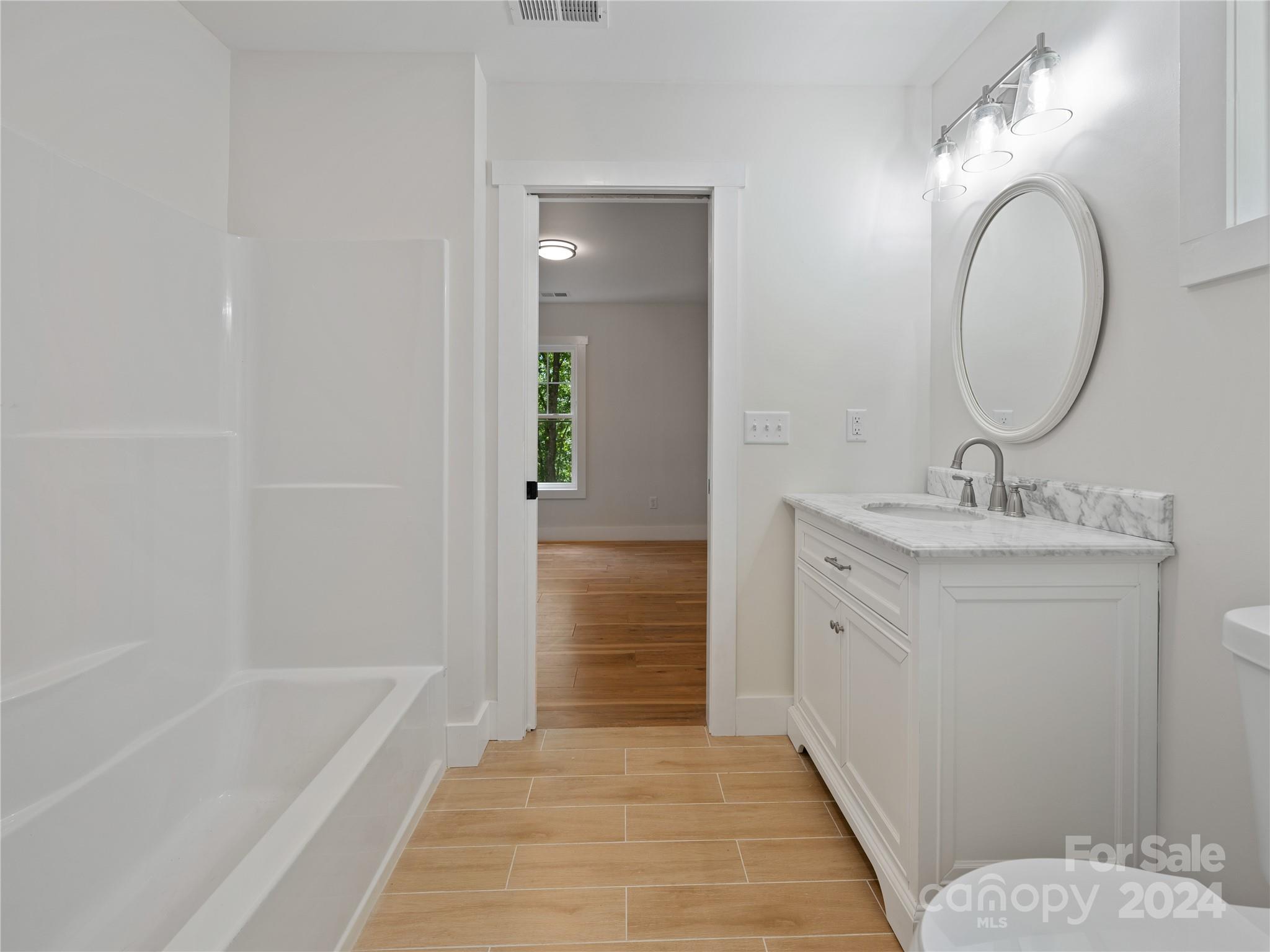 359 Tiptop Road Brevard, NC 28712 - Photo 35 of 48 a bathroom with a sink a toilet and shower