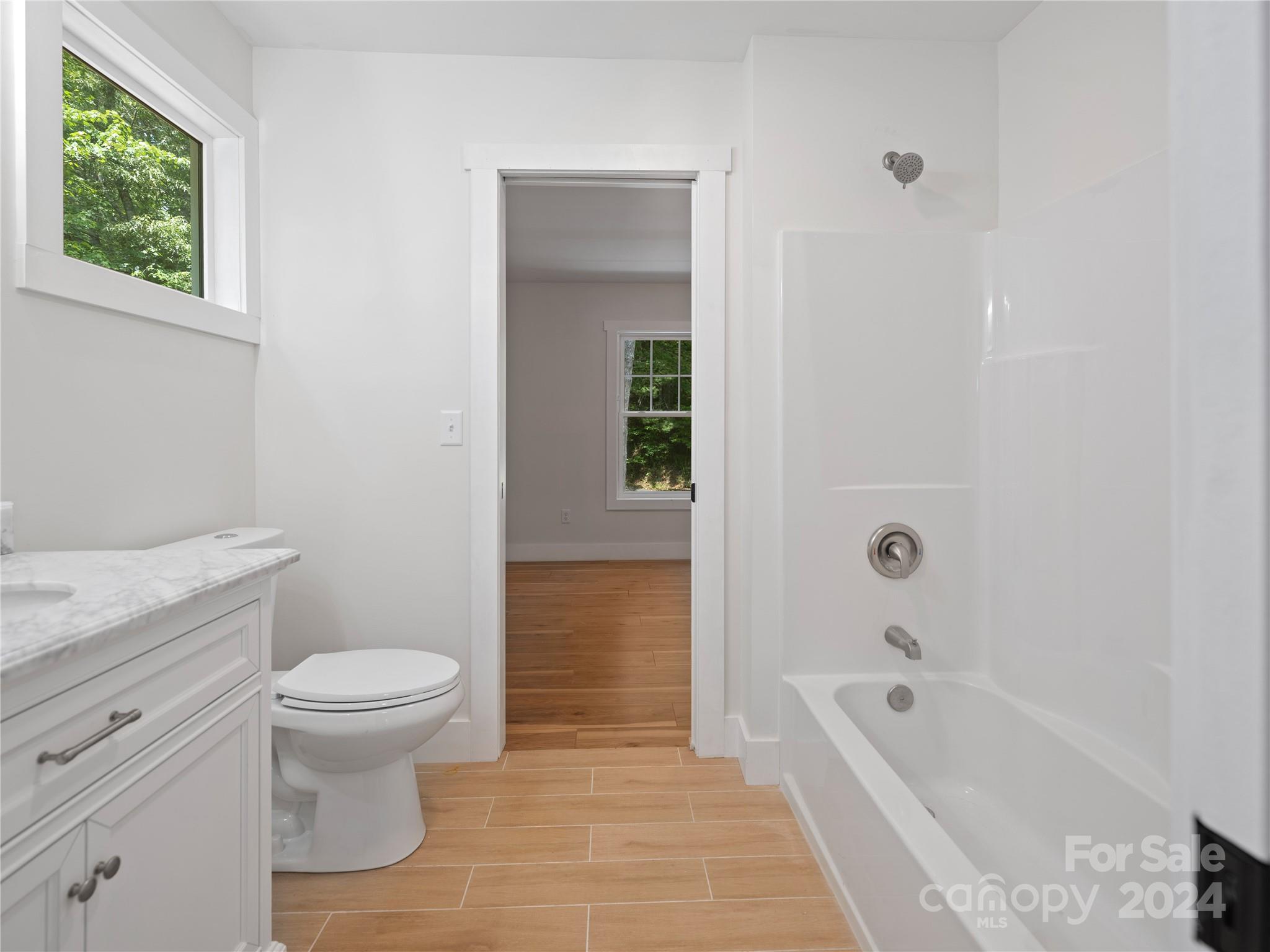359 Tiptop Road Brevard, NC 28712 - Photo 36 of 48 a bathroom with a sink a toilet and bathtub