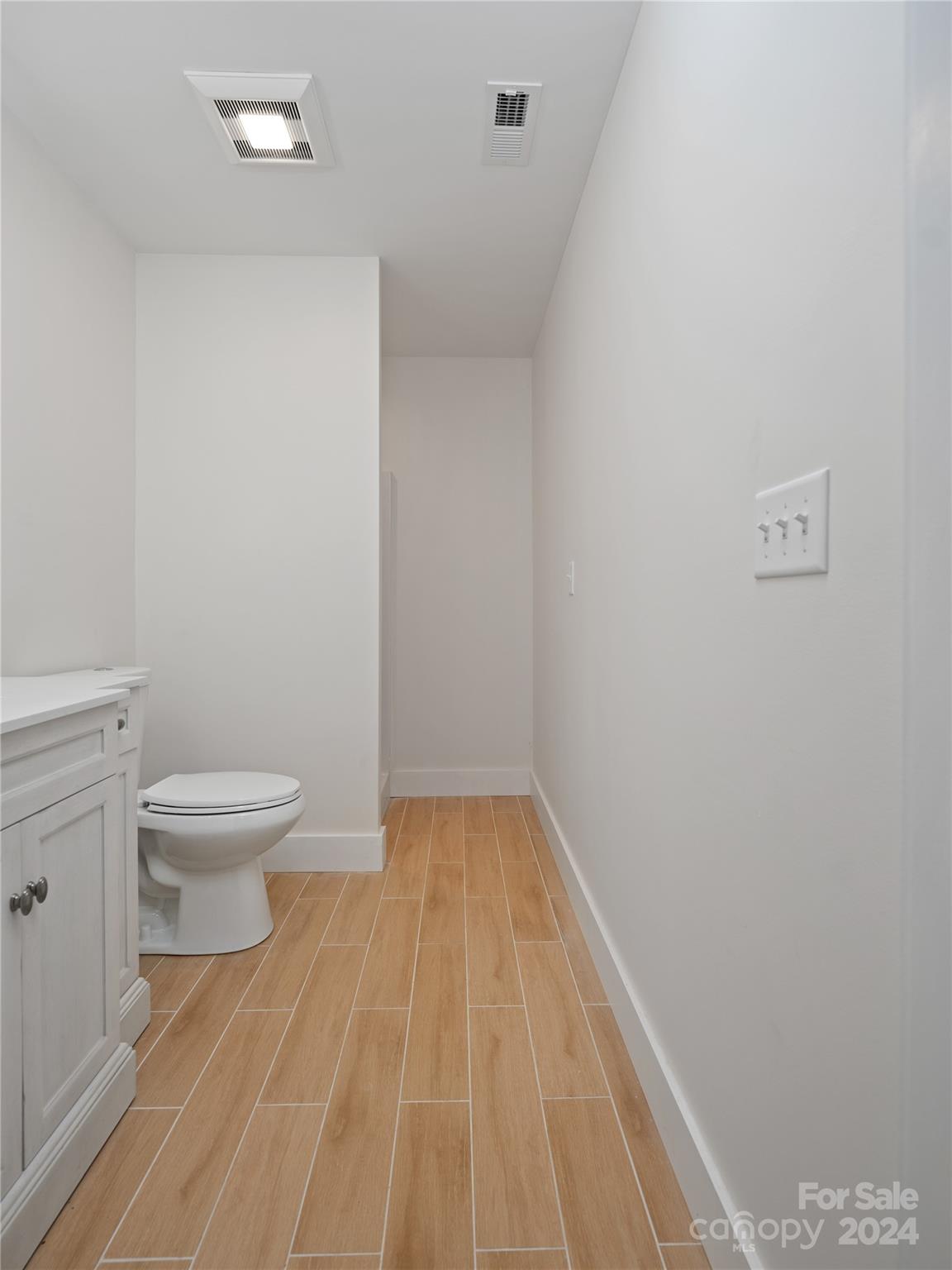 359 Tiptop Road Brevard, NC 28712 - Photo 40 of 48 a bathroom with a toilet and a vanity