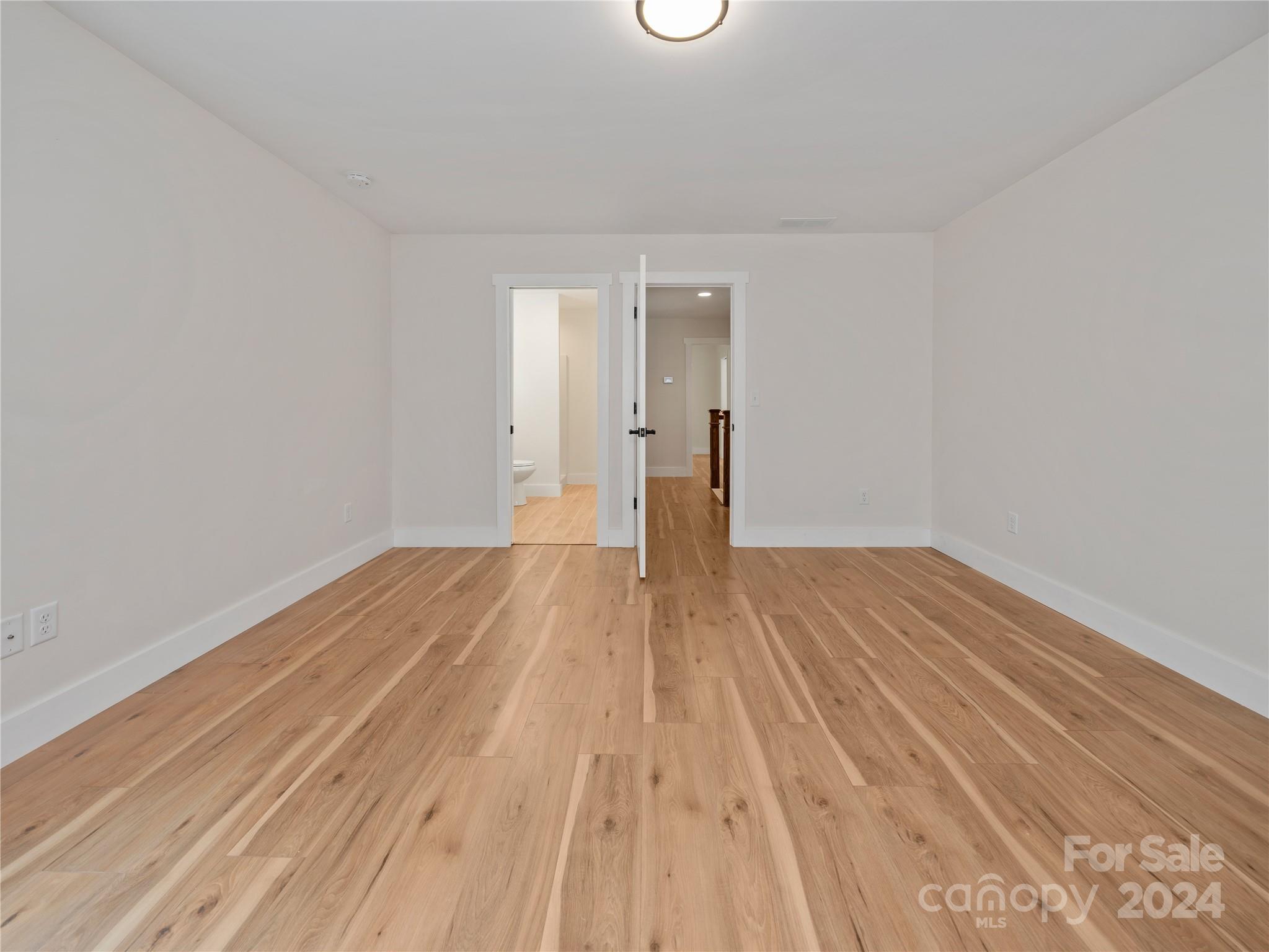 359 Tiptop Road Brevard, NC 28712 - Photo 41 of 48 a view of a room with wooden floor and white walls
