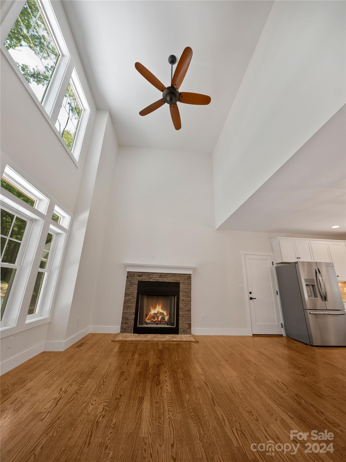 359 Tiptop Road Brevard, NC 28712 - Photo 6 of 48 a view of empty room with wooden floor and ceiling fan