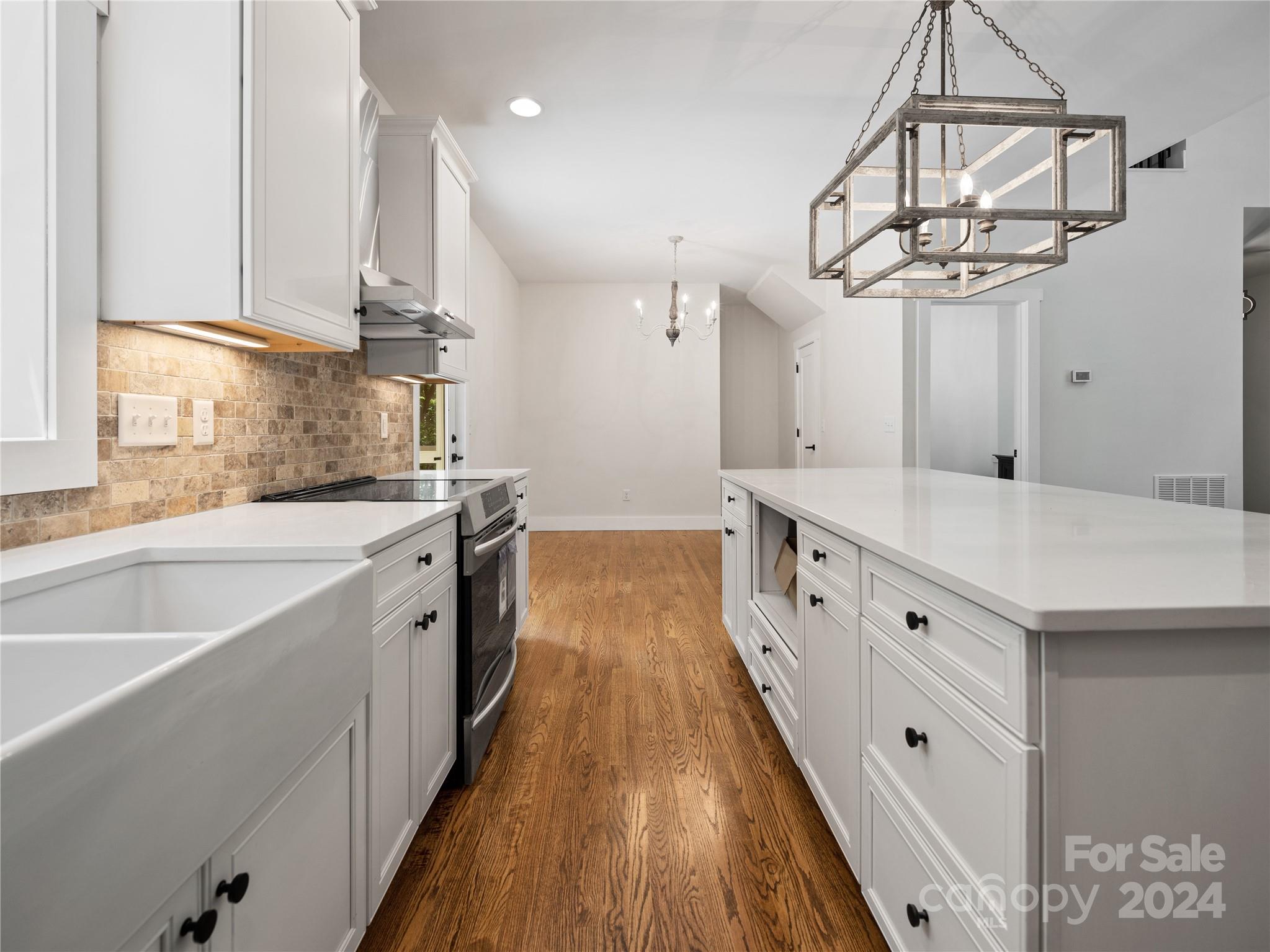 359 Tiptop Road Brevard, NC 28712 - Photo 8 of 48 a large white kitchen with a window and stainless steel appliances