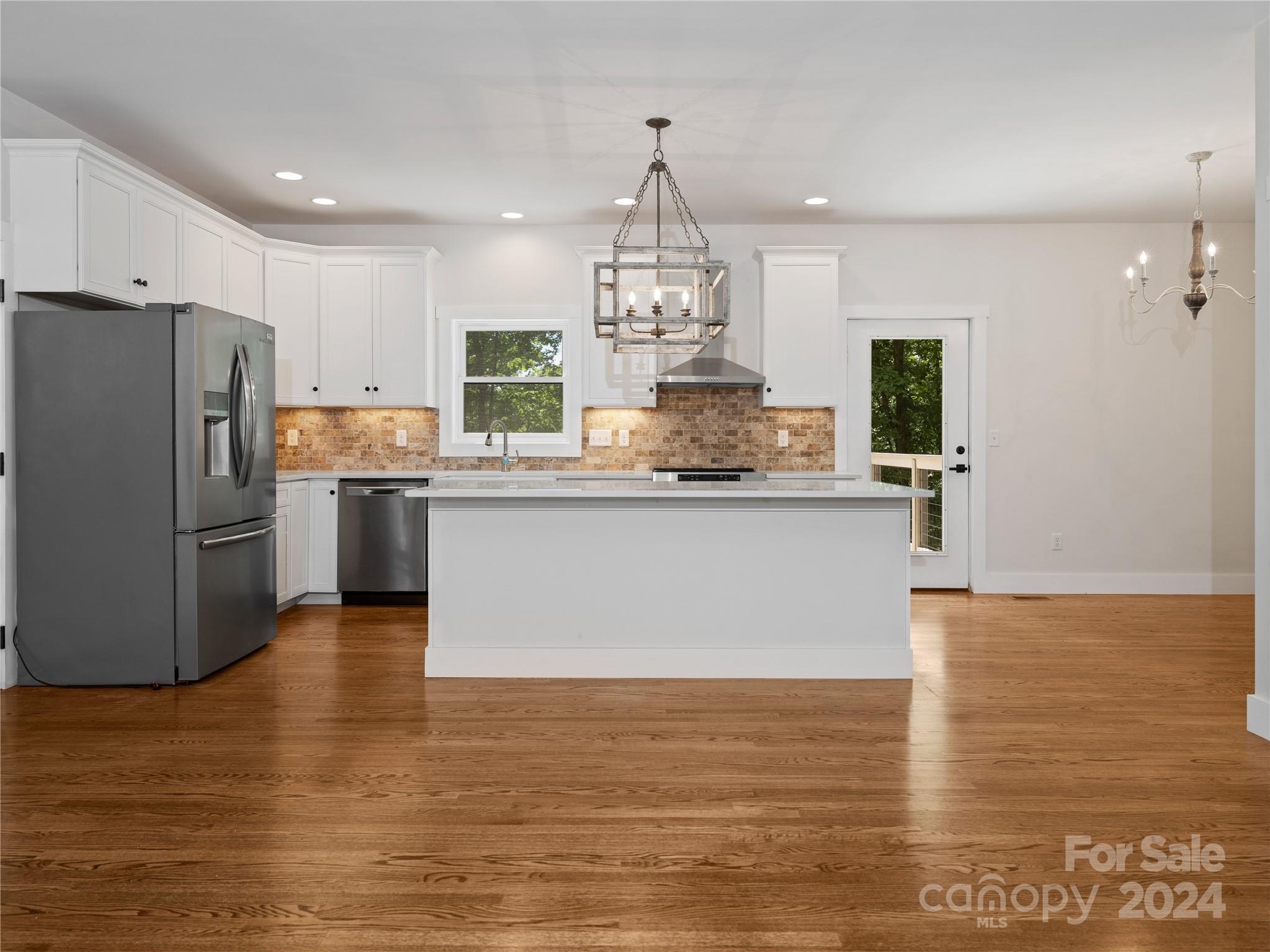 359 Tiptop Road Brevard, NC 28712 - Photo 10 of 48 a kitchen with stainless steel appliances granite countertop a sink a stove and refrigerator