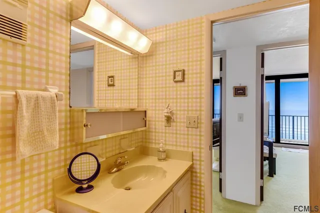 a bathroom with a sink a toilet and shower curtain