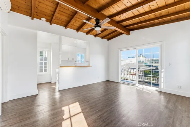 a view of wooden floor with a kitchen
