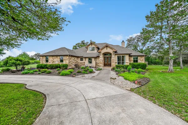 a front view of a house with a yard