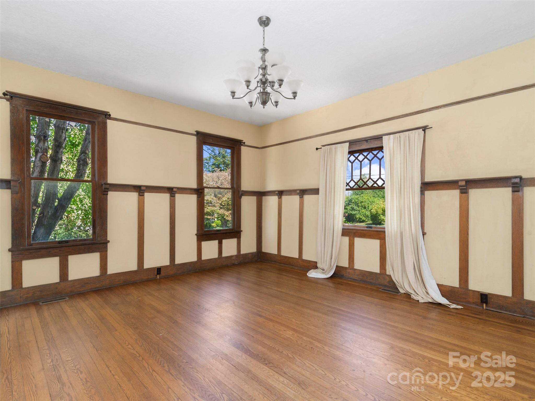 99 Walnut Street Waynesville, NC 28786 - Photo 16 of 34 a view of an empty room with wooden floor and a window