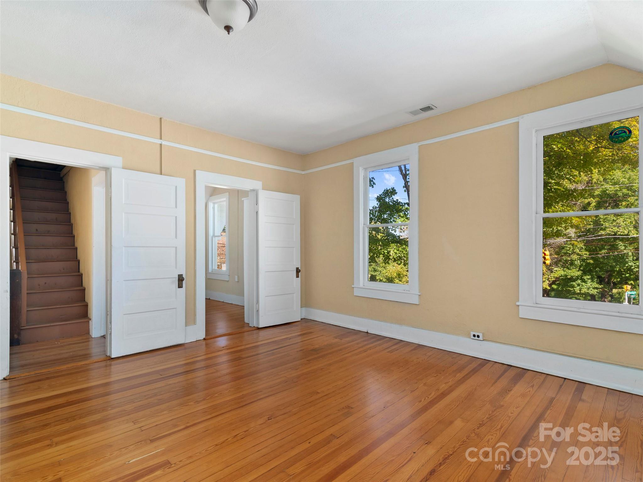99 Walnut Street Waynesville, NC 28786 - Photo 17 of 34 an empty room with wooden floor and windows