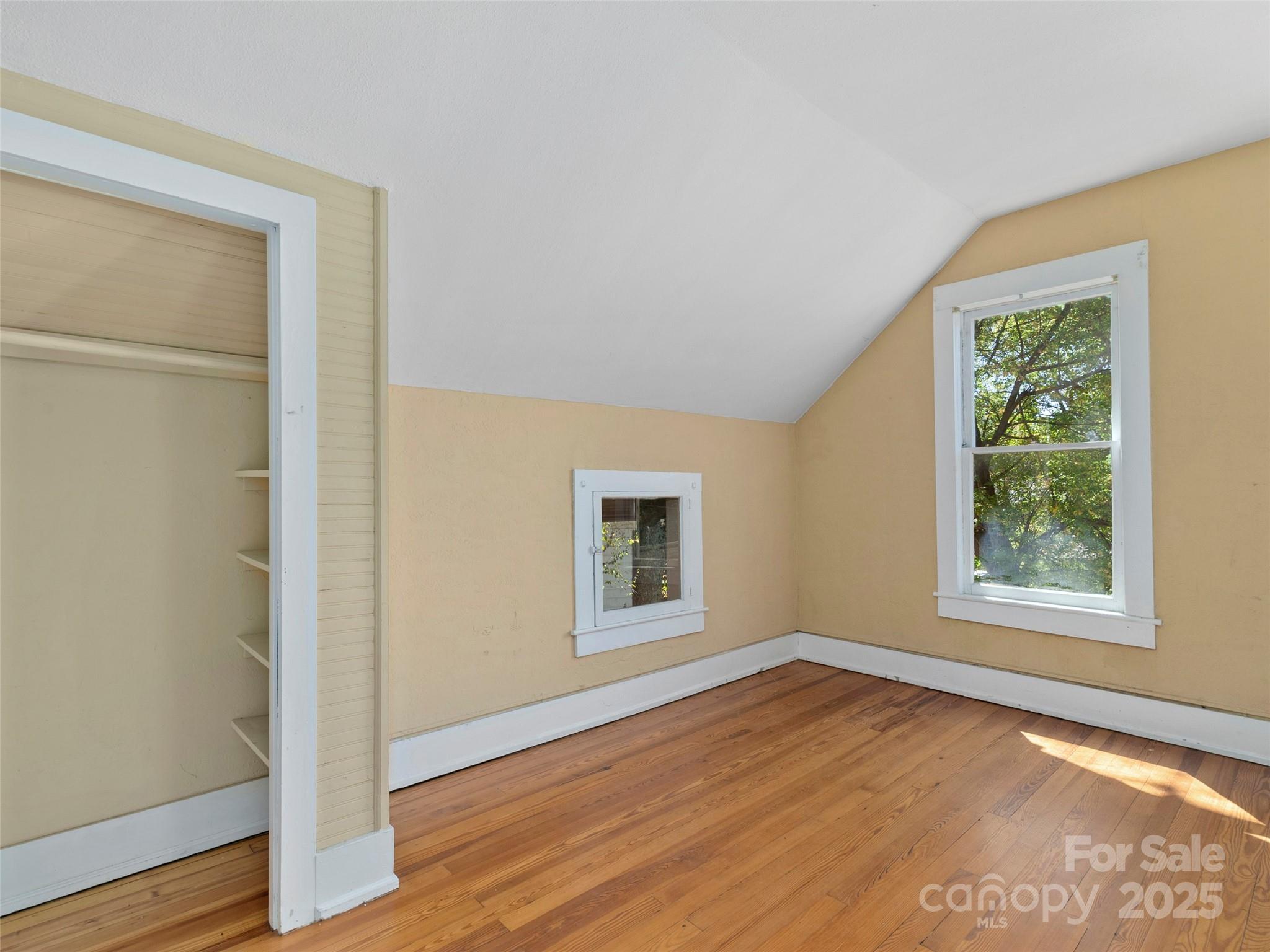 99 Walnut Street Waynesville, NC 28786 - Photo 19 of 34 an empty room with wooden floor and windows