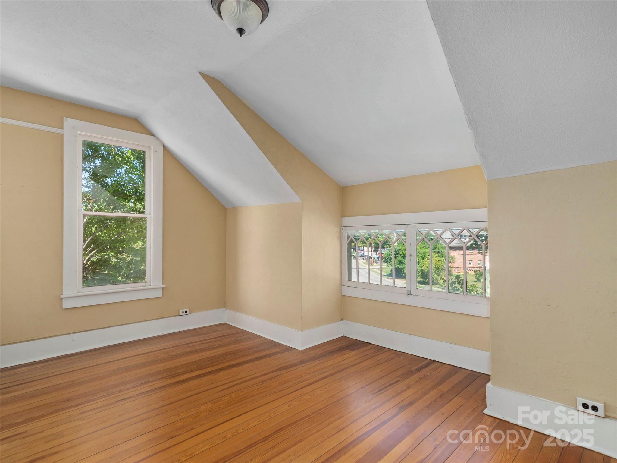 99 Walnut Street Waynesville, NC 28786 - Photo 23 of 34 an empty room with wooden floor and windows