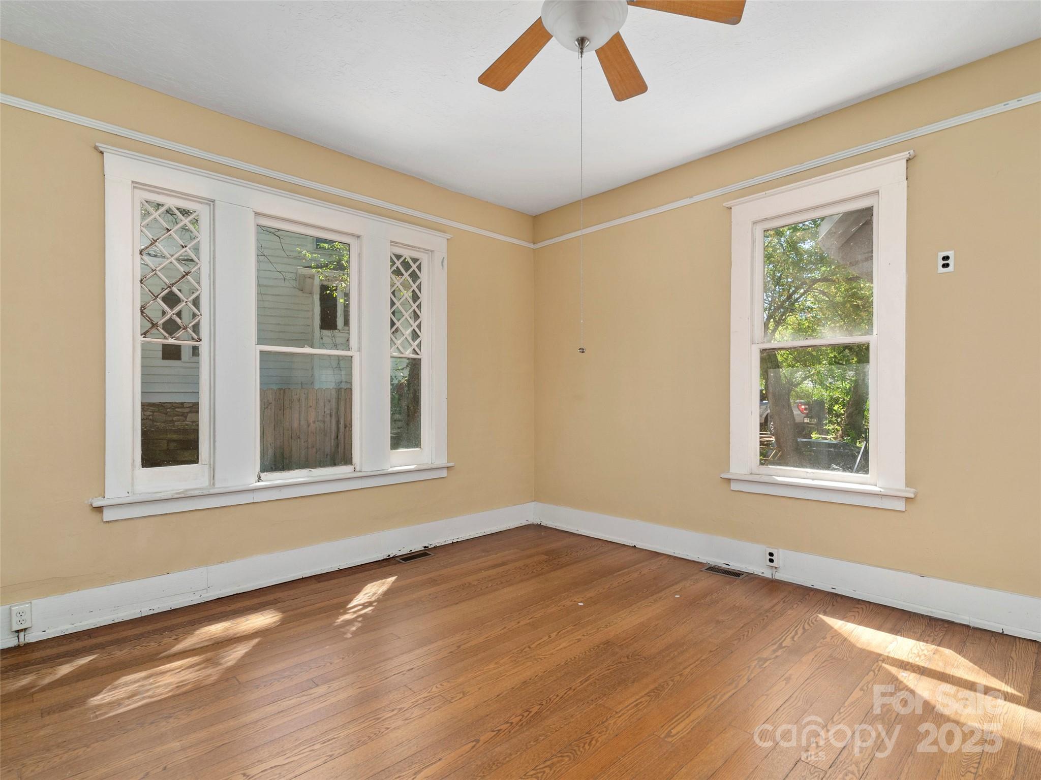 99 Walnut Street Waynesville, NC 28786 - Photo 7 of 34 a view of an empty room with wooden floor and a window