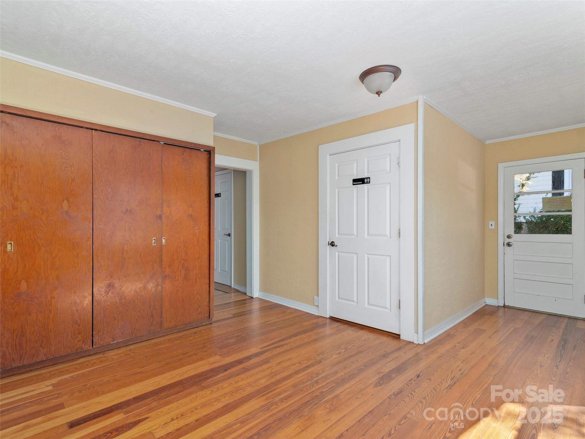99 Walnut Street Waynesville, NC 28786 - Photo 8 of 34 a view of an empty room with wooden floor and closet