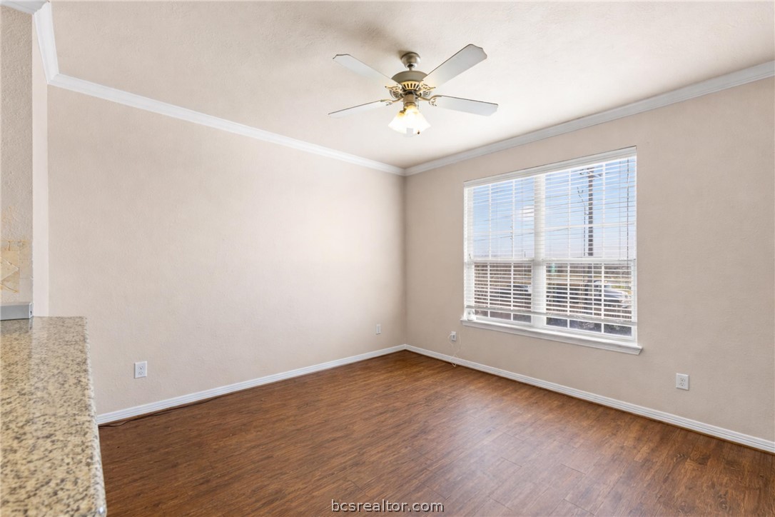 1198 Jones-Butler Road, Unit 3005 College Station, TX 77840 - Photo 5 of 24 a view of an empty room with wooden floor and a window
