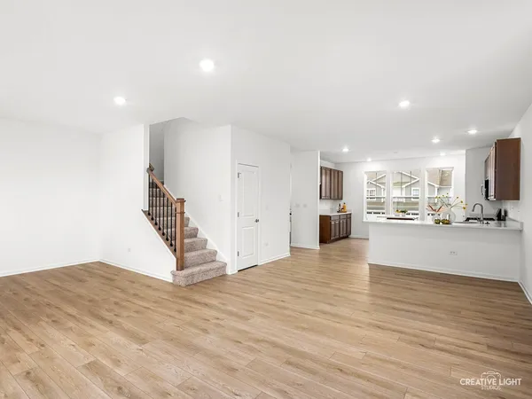 a view of kitchen and hall with wooden floor
