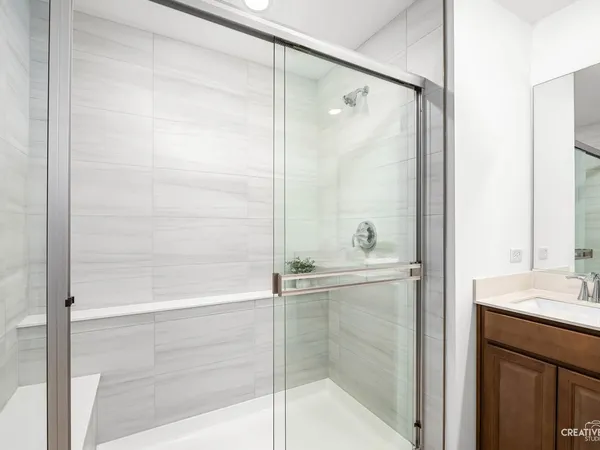 a bathroom with a shower and a sink