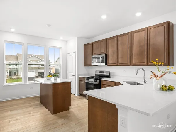 a kitchen with stainless steel appliances granite countertop a sink stove and refrigerator