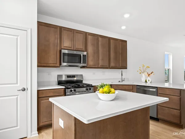a kitchen with a sink a stove and microwave
