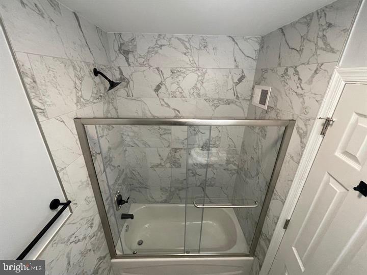 4458 North 20th Street Philadelphia, PA 19140 - Photo 10 of 14 Elegant marble bath with modern glass enclosure.