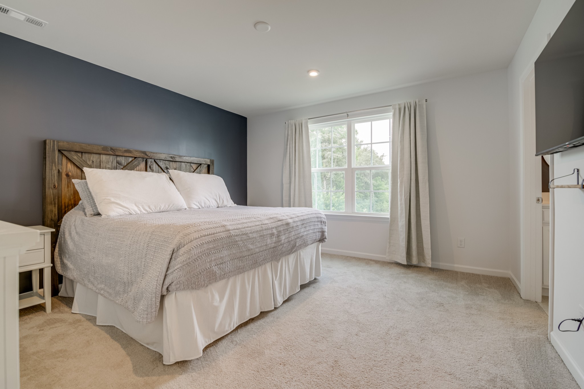 646 Castle Road Mount Juliet, TN 37122 - Photo 18 of 31 a large bed sitting in a bedroom next to a window