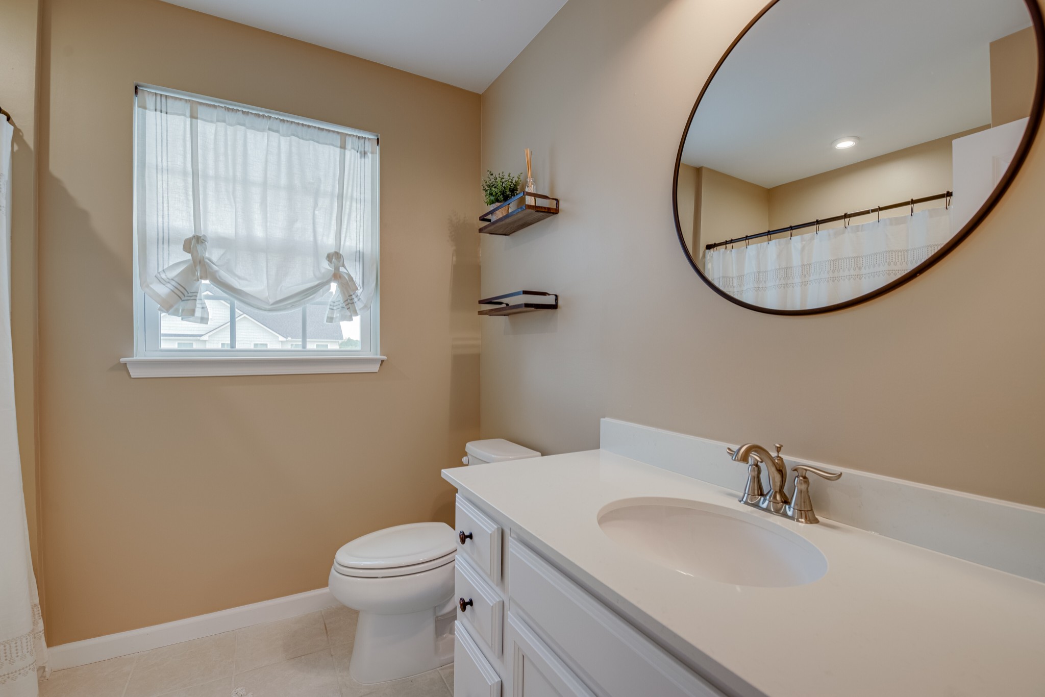 646 Castle Road Mount Juliet, TN 37122 - Photo 27 of 31 a bathroom with a sink a mirror and a toilet