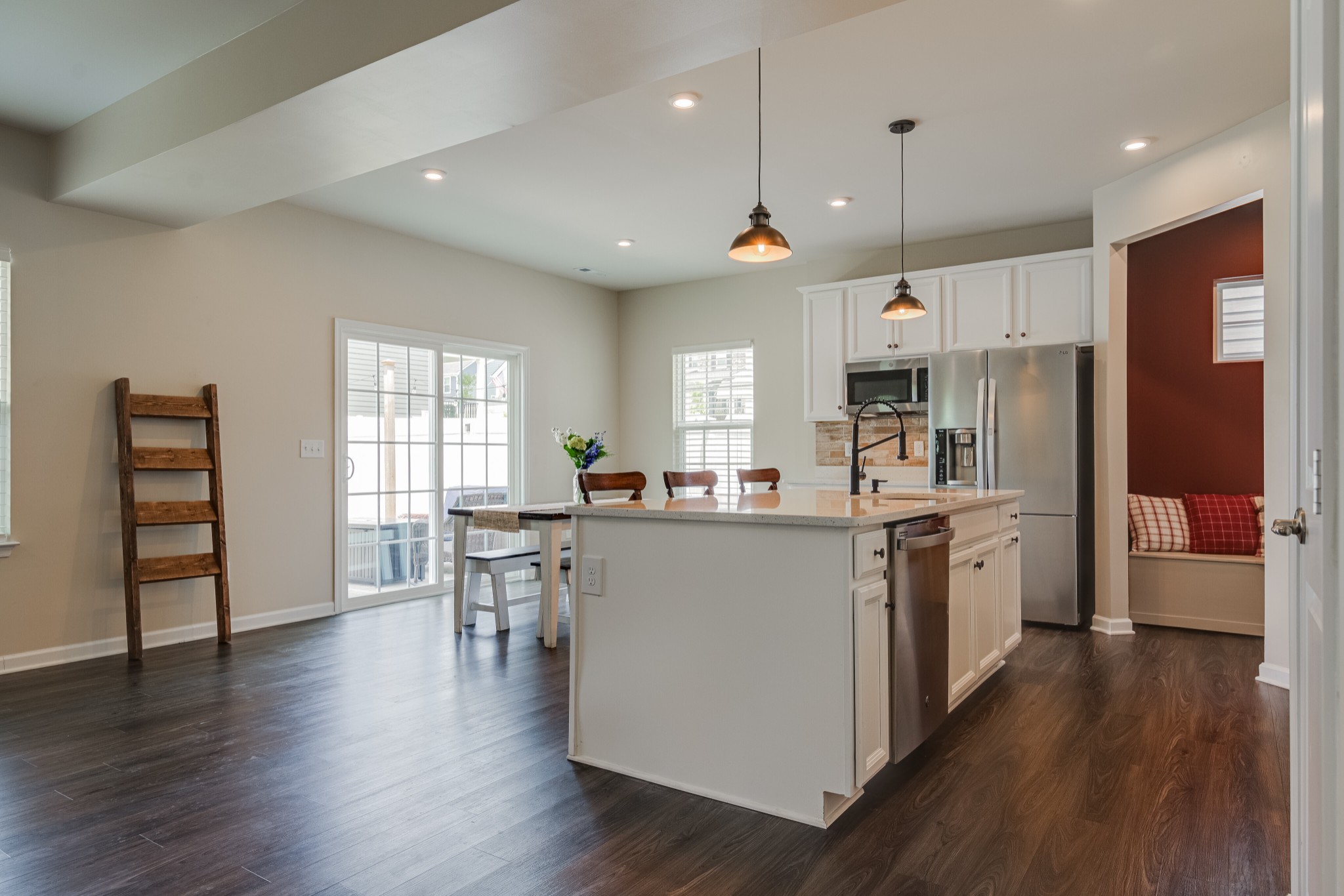 646 Castle Road Mount Juliet, TN 37122 - Photo 6 of 31 a kitchen with stainless steel appliances granite countertop a refrigerator a stove top oven a sink dishwasher and a dining table with wooden floor