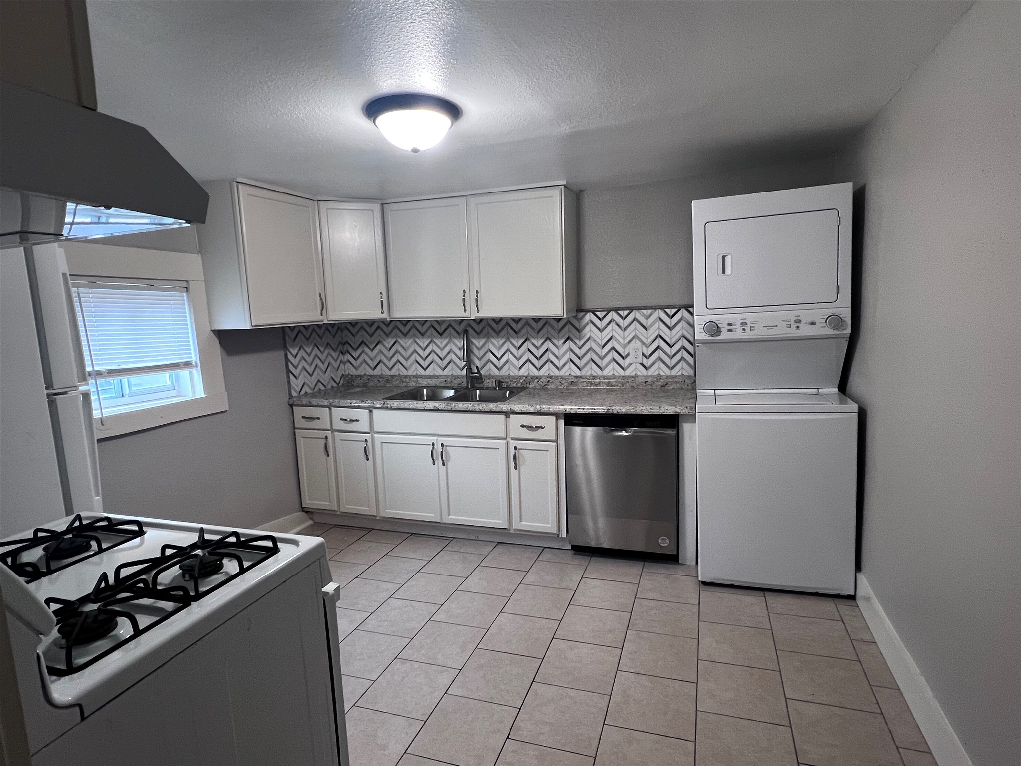 712 40th Street, Unit 2 Galveston, TX 77550 - Photo 2 of 8 a kitchen with a stove sink and cabinets