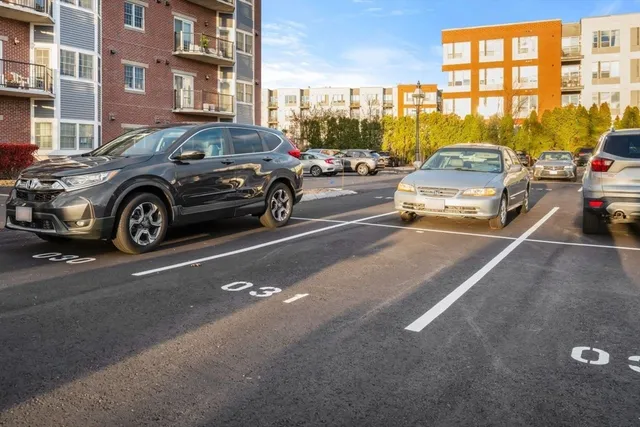 a view of a cars park in front of a building