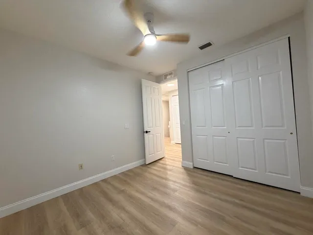 a view of an empty room and wooden floor